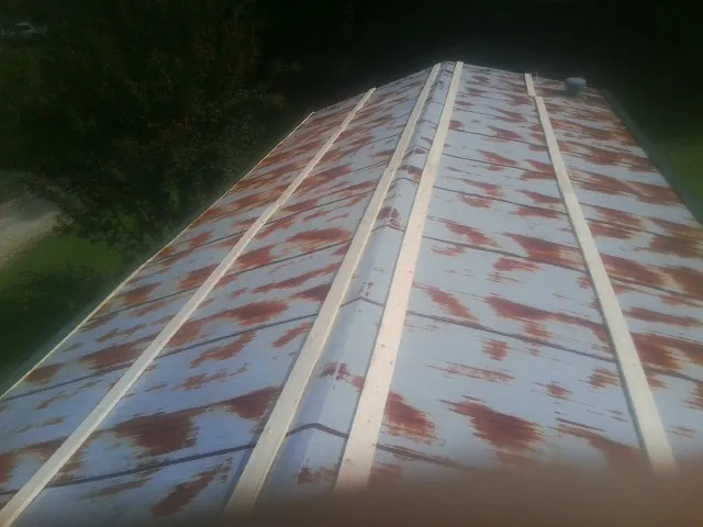 Rusted metal roof panels with new wood purlins before replacement — Storm Damage Roof Repair in Vineland by Roofing Brothers